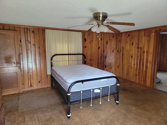 195 N Mattie Ave, Sycamore, GA 31790 - carpeted bedroom with wood walls, a textured ceiling, baseboards, and ceiling fan
