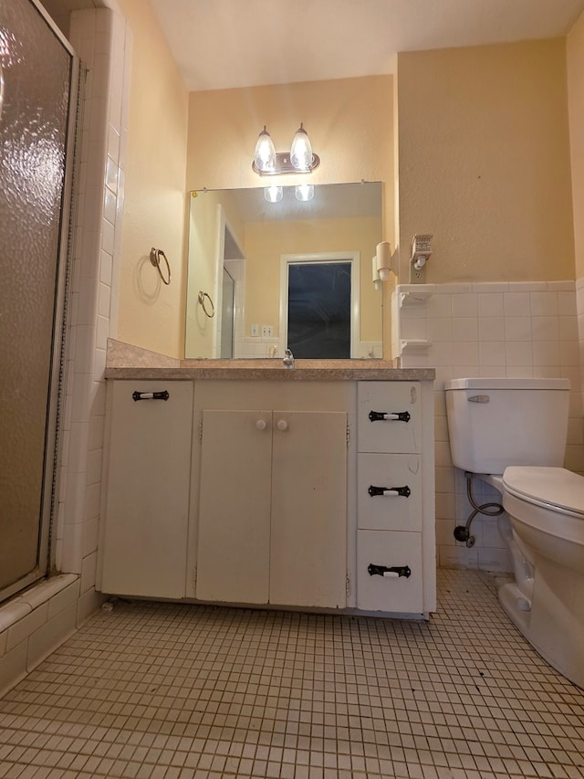 bathroom with toilet, tile walls, a shower stall, and tile patterned flooring