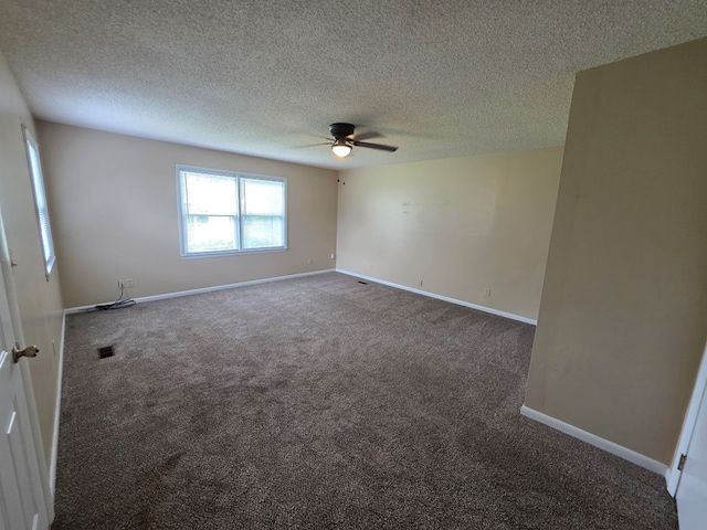 unfurnished room with carpet floors, a ceiling fan, and baseboards