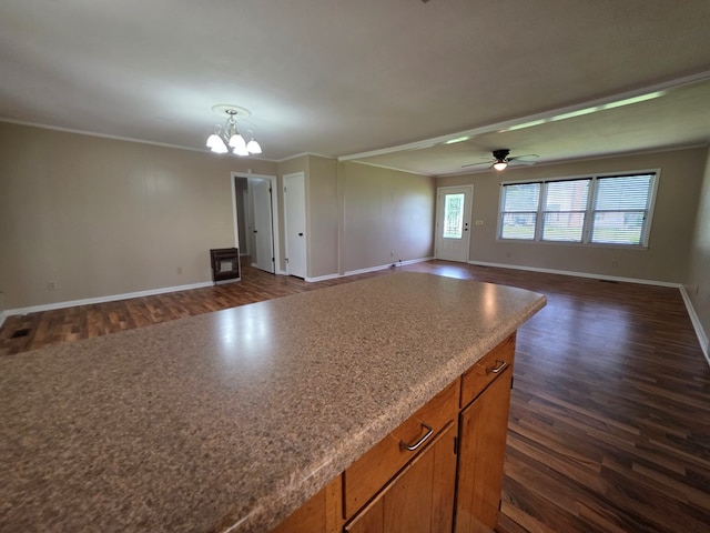 interior space with crown molding, dark wood-style flooring, baseboards, and ceiling fan with notable chandelier