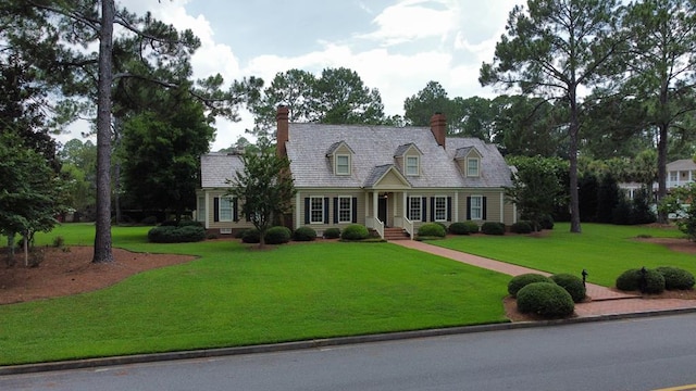 302 W 26th St, Tifton, GA 31794 - new england style home featuring a chimney and a front lawn