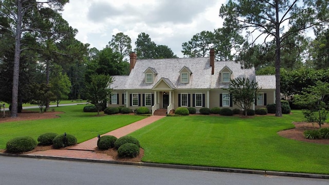 302 W 26th St, Tifton, GA 31794 - cape cod house featuring a front lawn and a chimney