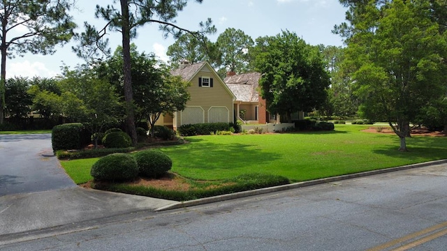 302 W 26th St, Tifton, GA 31794 - view of front facade with a front yard and a chimney