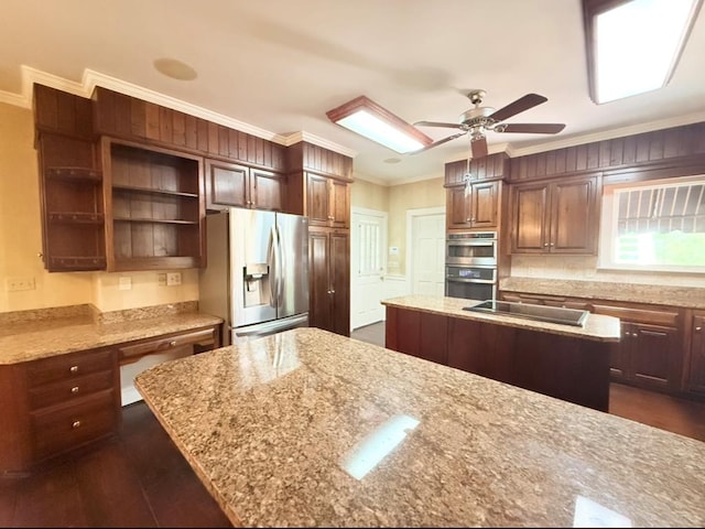302 W 26th St, Tifton, GA 31794 - kitchen featuring appliances with stainless steel finishes, a kitchen island, crown molding, light stone counters, and a ceiling fan