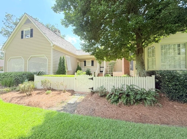 302 W 26th St, Tifton, GA 31794 - view of front of property with a fenced front yard, a gate, a chimney, and roof with shingles