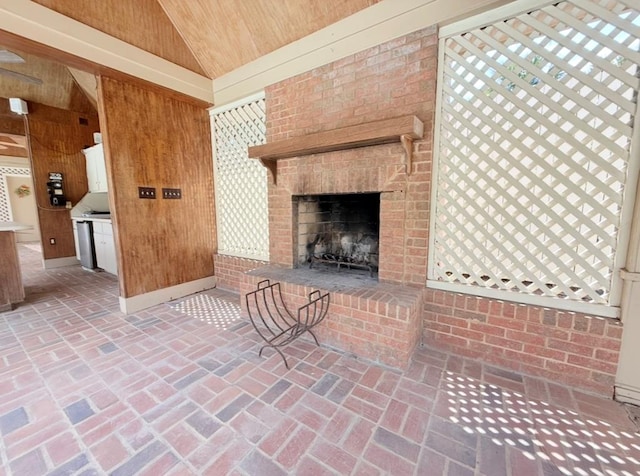 302 W 26th St, Tifton, GA 31794 - unfurnished living room featuring wood ceiling, wooden walls, a brick fireplace, brick floors, and high vaulted ceiling