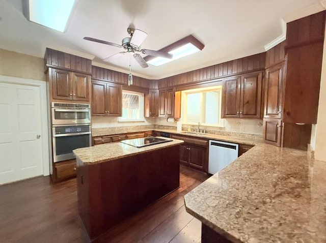 302 W 26th St, Tifton, GA 31794 - kitchen featuring dishwasher, stainless steel double oven, a center island, light stone countertops, and crown molding