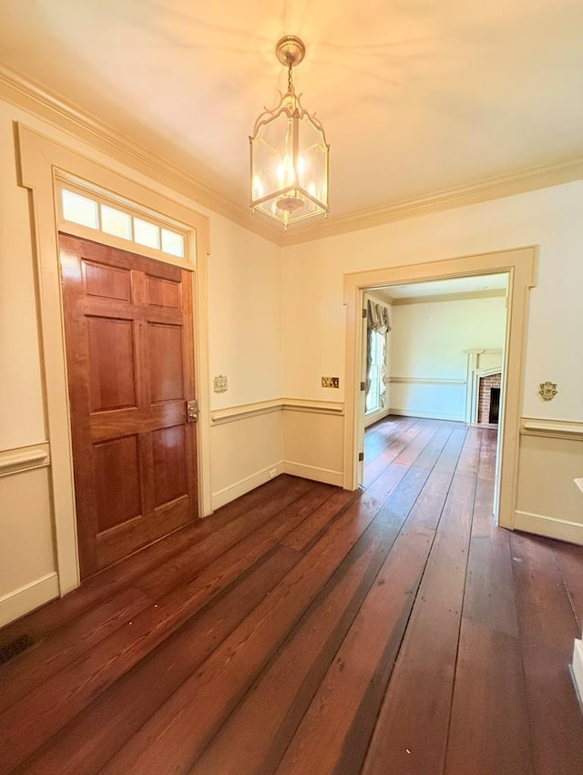 302 W 26th St, Tifton, GA 31794 - foyer featuring dark wood-style flooring, a chandelier, and ornamental molding