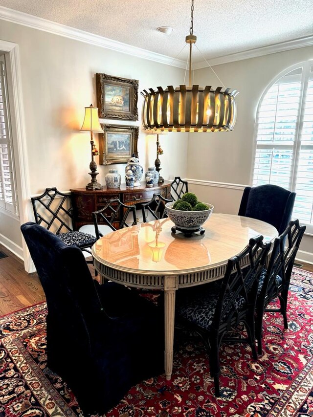 11 Ridgewood Dr, Tifton, GA 31793 - dining room featuring a textured ceiling, ornamental molding, and wood finished floors