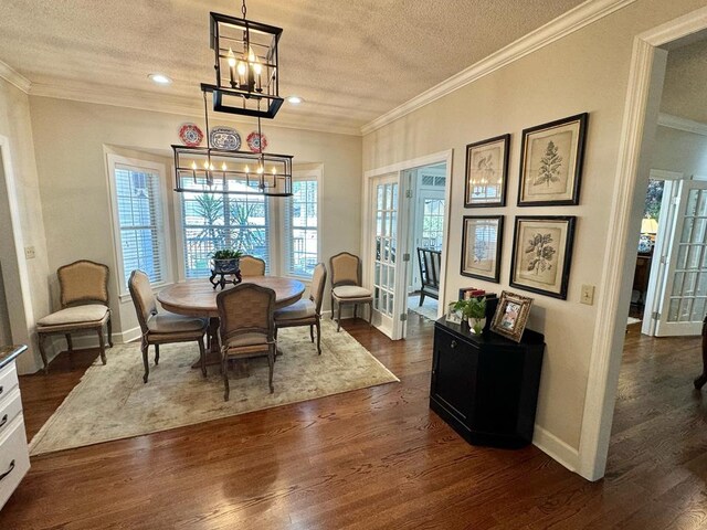 11 Ridgewood Dr, Tifton, GA 31793 - dining area with a textured ceiling, ornamental molding, a chandelier, baseboards, and dark wood-style floors