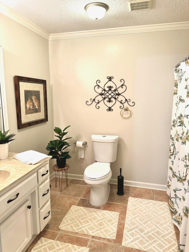 11 Ridgewood Dr, Tifton, GA 31793 - bathroom featuring vanity, ornamental molding, visible vents, tile patterned flooring, and toilet
