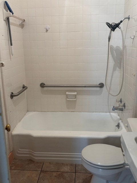 407 N Ridge Ave, Tifton, GA 31794 - bathroom featuring tile patterned flooring, toilet, and bathing tub / shower combination