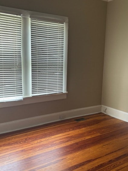 407 N Ridge Ave, Tifton, GA 31794 - empty room with baseboards, wood finished floors, and plenty of natural light