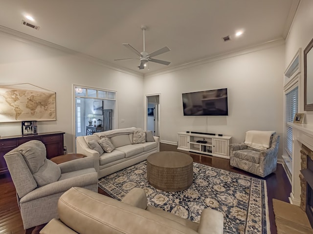 74 Surrey Cir, Tifton, GA 31793 - living room featuring dark wood-type flooring, a stone fireplace, a ceiling fan, ornamental molding, and recessed lighting