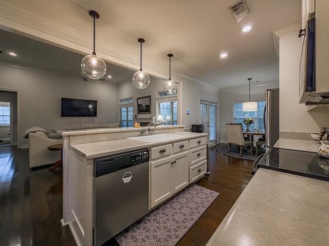 74 Surrey Cir, Tifton, GA 31793 - kitchen featuring appliances with stainless steel finishes, white cabinets, ornamental molding, dark wood-type flooring, and an island with sink