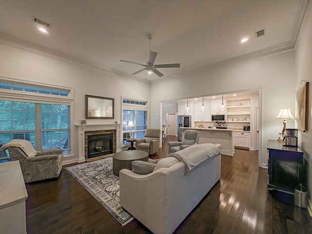 74 Surrey Cir, Tifton, GA 31793 - living area featuring crown molding, a ceiling fan, dark wood finished floors, a fireplace, and recessed lighting