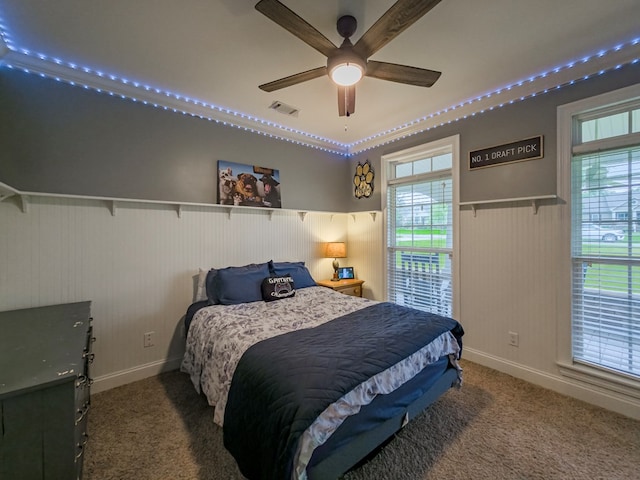 74 Surrey Cir, Tifton, GA 31793 - carpeted bedroom featuring wainscoting, multiple windows, and ceiling fan