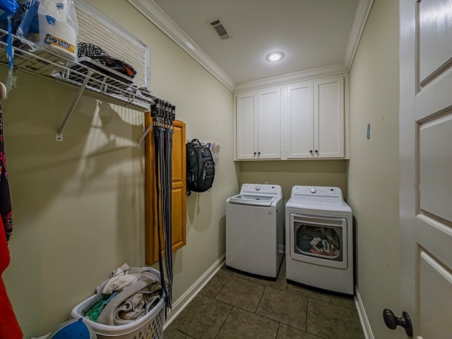74 Surrey Cir, Tifton, GA 31793 - washroom with washer and dryer, dark tile patterned floors, recessed lighting, ornamental molding, and cabinet space