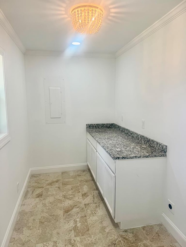 702 N Livingston St, Sylvester, GA 31791 - bathroom with electric panel, crown molding, and a chandelier