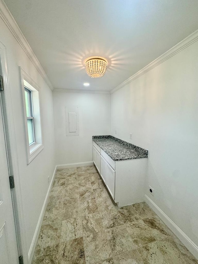 702 N Livingston St, Sylvester, GA 31791 - laundry room with ornamental molding, light stone finish floors, and a chandelier