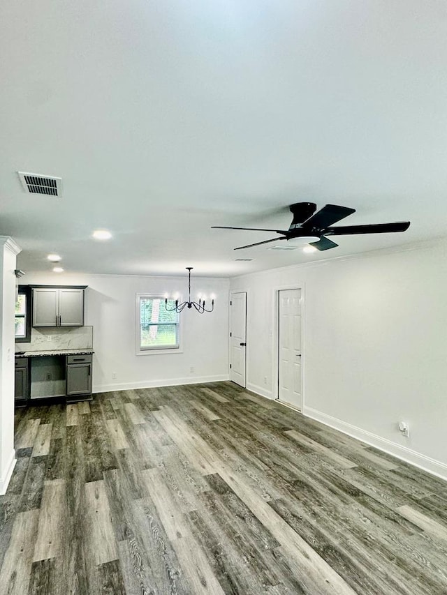 702 N Livingston St, Sylvester, GA 31791 - unfurnished living room with dark wood-style flooring, a chandelier, and ceiling fan
