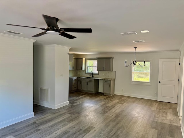 702 N Livingston St, Sylvester, GA 31791 - unfurnished living room with a chandelier, crown molding, wood finished floors, and ceiling fan