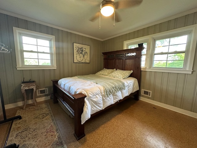 bedroom with baseboards, visible vents, and crown molding