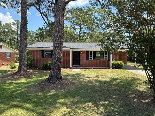 2411 Davis Ave, Tifton, GA 31794 - ranch-style house with concrete driveway, a front lawn, and brick siding