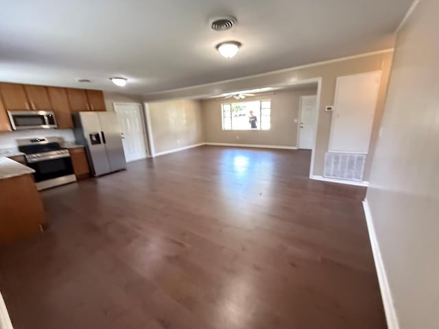 2411 Davis Ave, Tifton, GA 31794 - kitchen featuring appliances with stainless steel finishes, dark wood finished floors, brown cabinets, light countertops, and ceiling fan