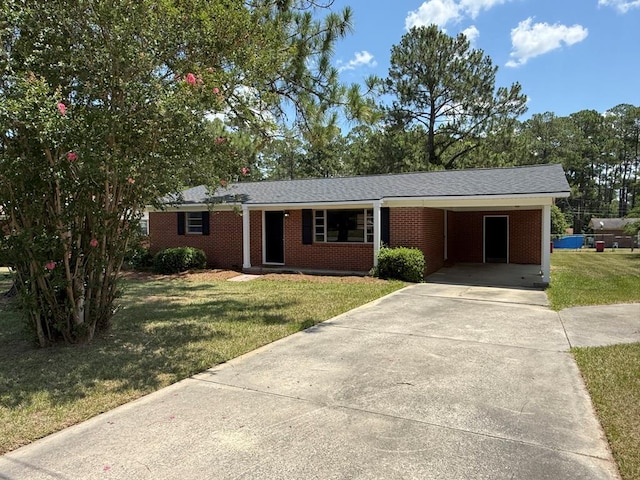 2411 Davis Ave, Tifton, GA 31794 - ranch-style house with concrete driveway, a front yard, brick siding, and an attached carport