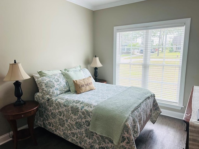 bedroom featuring crown molding, baseboards, and wood finished floors