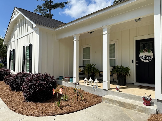 property entrance featuring a porch, board and batten siding, and a shingled roof