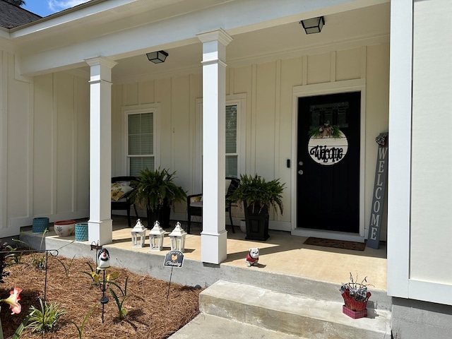 entrance to property featuring covered porch and board and batten siding