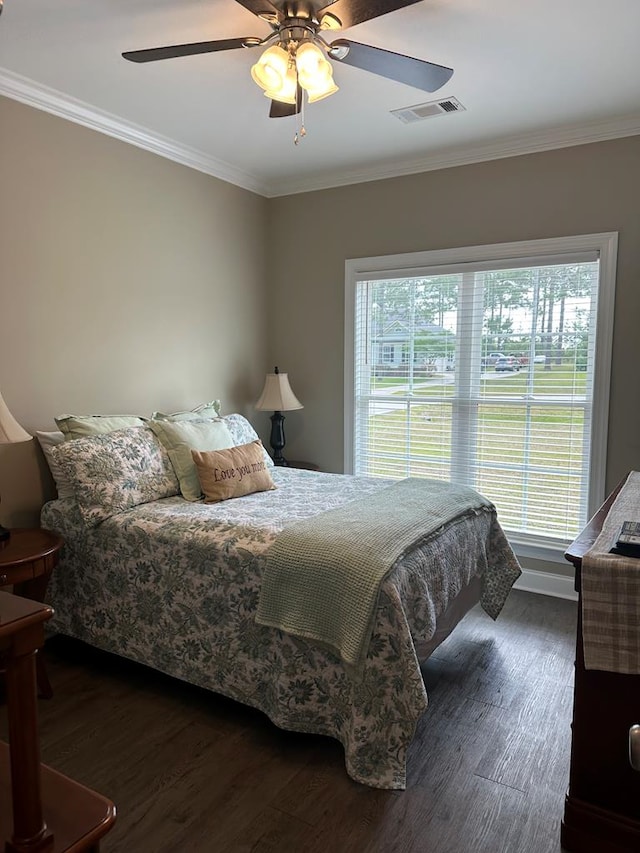 bedroom with visible vents, ornamental molding, dark wood-style flooring, and multiple windows