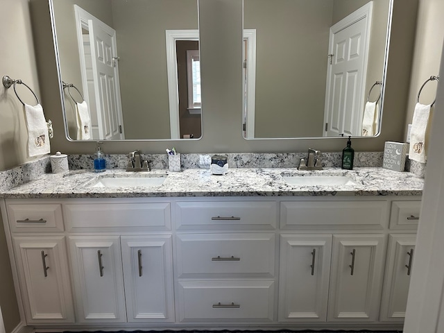 bathroom featuring double vanity and a sink