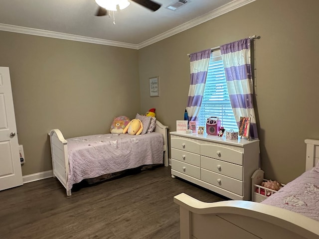 bedroom with visible vents, dark wood finished floors, crown molding, and ceiling fan