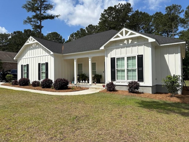 view of front of home featuring board and batten siding, a front yard, and a porch