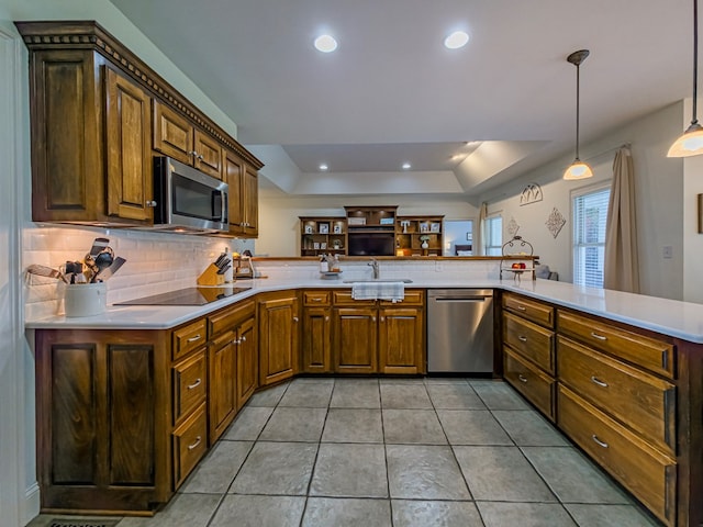 114 Creole Ct, Fitzgerald, GA 31750 - kitchen featuring appliances with stainless steel finishes, a peninsula, light countertops, tasteful backsplash, and a raised ceiling
