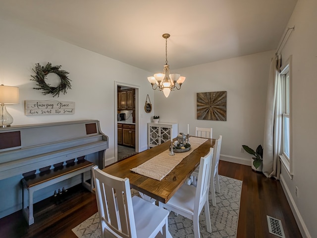 114 Creole Ct, Fitzgerald, GA 31750 - dining area featuring a chandelier and dark wood finished floors