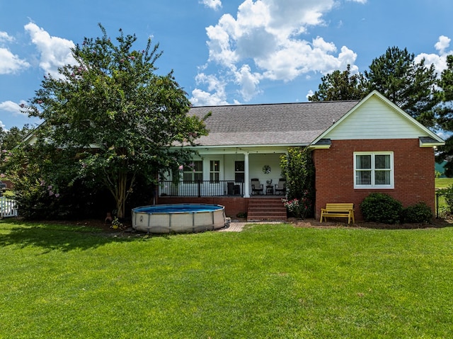 114 Creole Ct, Fitzgerald, GA 31750 - ranch-style house featuring brick siding, a front lawn, an outdoor pool, and roof with shingles