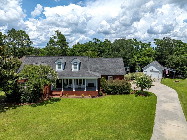 114 Creole Ct, Fitzgerald, GA 31750 - cape cod home featuring a porch, a front lawn, concrete driveway, a garage, and a shingled roof