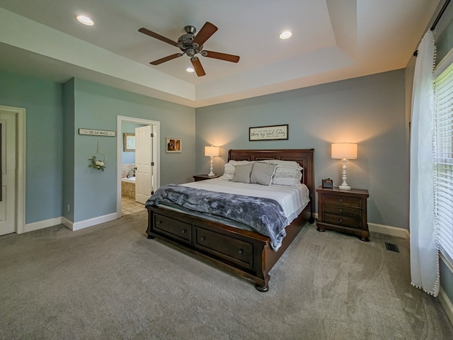 114 Creole Ct, Fitzgerald, GA 31750 - carpeted bedroom with recessed lighting, a raised ceiling, ensuite bathroom, and a ceiling fan