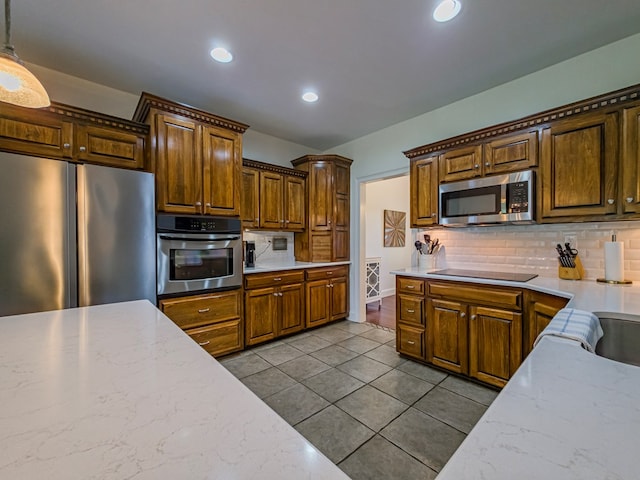114 Creole Ct, Fitzgerald, GA 31750 - kitchen with stainless steel appliances, tasteful backsplash, tile patterned floors, recessed lighting, and light stone countertops