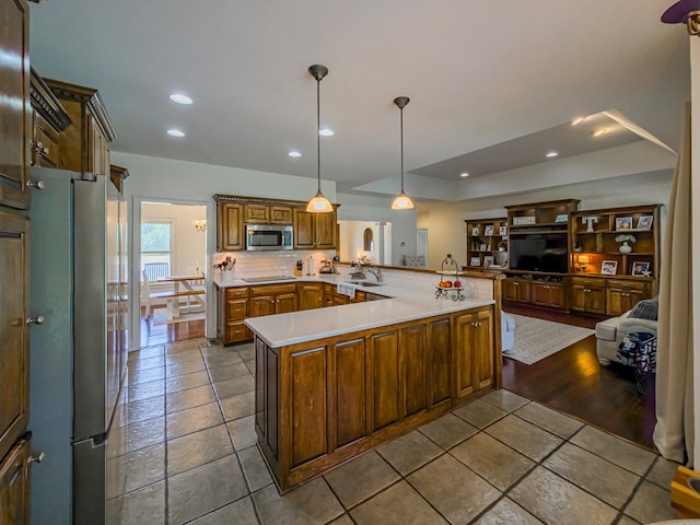 114 Creole Ct, Fitzgerald, GA 31750 - kitchen with stainless steel appliances, light countertops, recessed lighting, dark tile patterned floors, and open floor plan