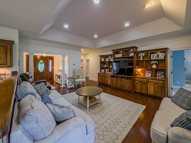 114 Creole Ct, Fitzgerald, GA 31750 - living room featuring decorative columns, a tray ceiling, dark wood-style floors, and recessed lighting