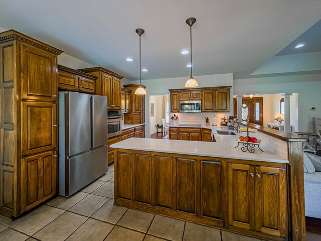 114 Creole Ct, Fitzgerald, GA 31750 - kitchen featuring stainless steel appliances, decorative backsplash, light countertops, light tile patterned flooring, and decorative columns