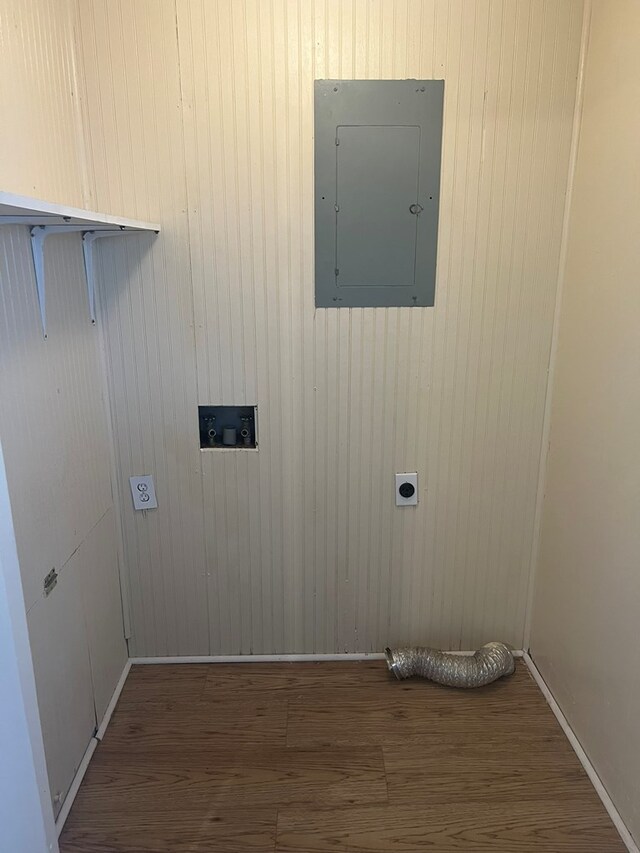 clothes washing area featuring laundry area, hookup for a washing machine, electric dryer hookup, electric panel, and wood finished floors