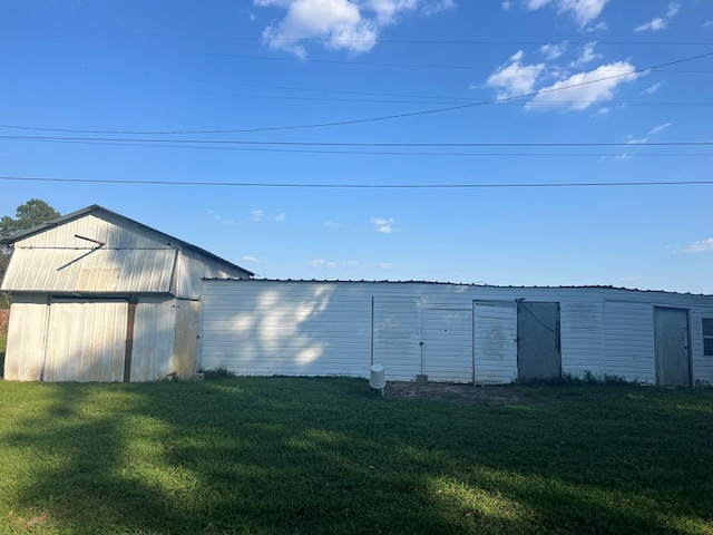 view of pole building with a yard