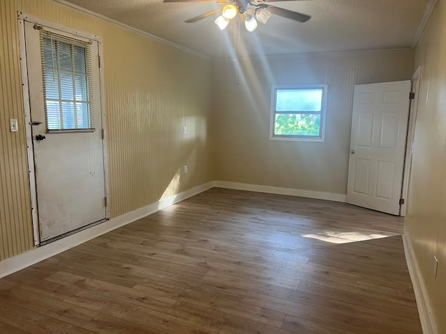 bonus room with a textured ceiling, baseboards, a ceiling fan, and wood finished floors