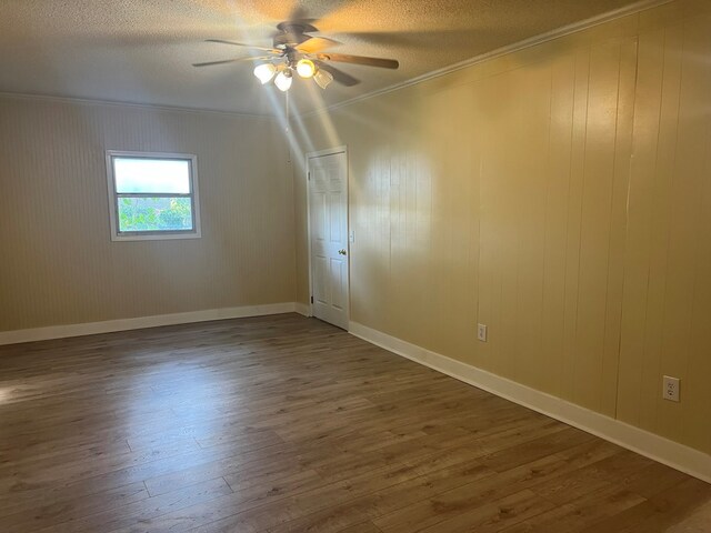 bonus room with ceiling fan, a textured ceiling, baseboards, and dark wood finished floors